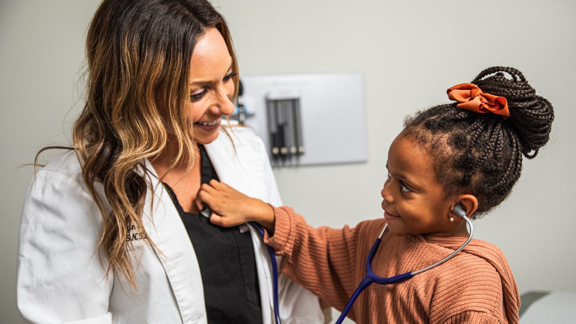 MEC Compliance Reporting image Pediatric doctor with patient
