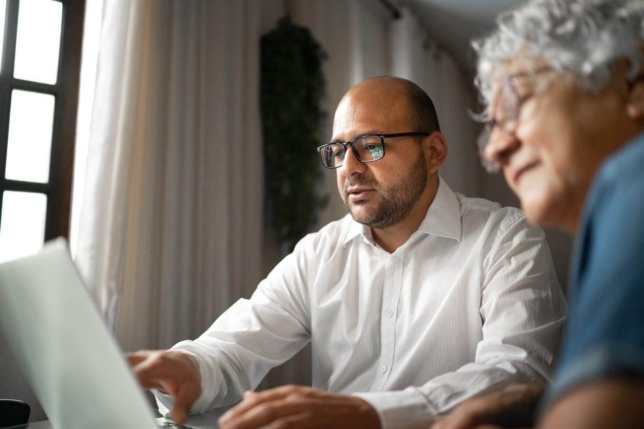 x-rays Son helping his mother navigate health insurance questions at the computer