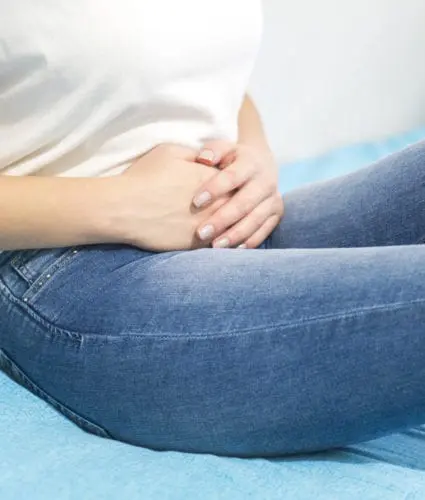 Injuries - Woman holding her stomach